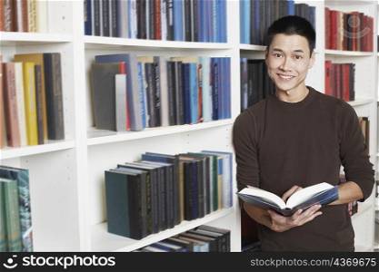 Portrait of a businessman holding a book smiling