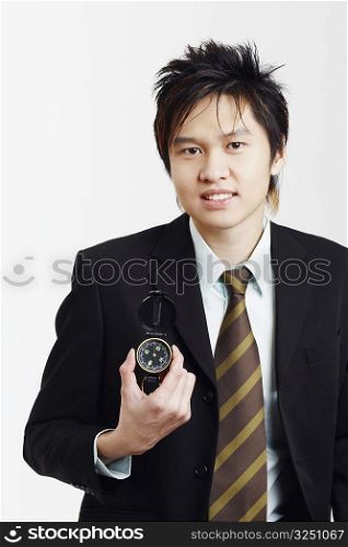 Portrait of a businessman holding a compass