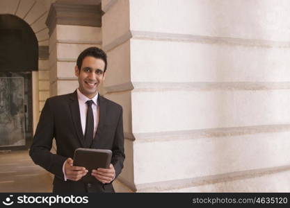 Portrait of a businessman holding a digital tablet , INDIA , DELHI