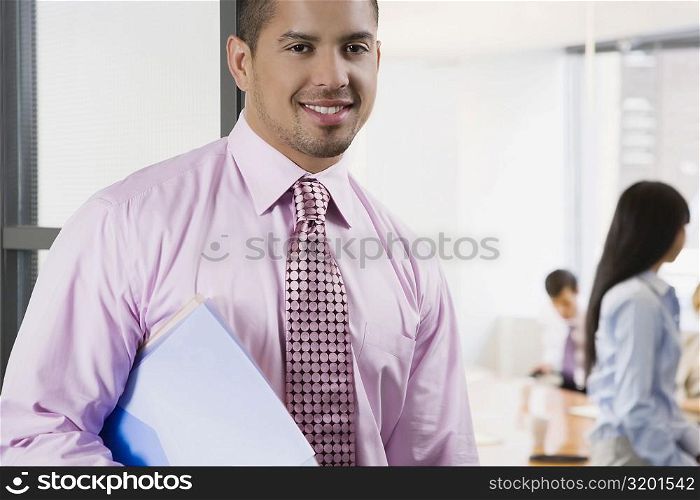 Portrait of a businessman holding a file