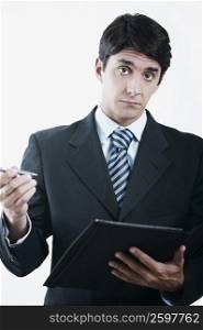 Portrait of a businessman holding a file and a pen