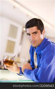 Portrait of a businessman holding a glass