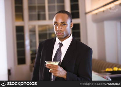 Portrait of a businessman holding a glass of martini