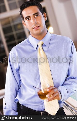 Portrait of a businessman holding a glass of wine