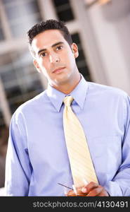 Portrait of a businessman holding a glass of wine