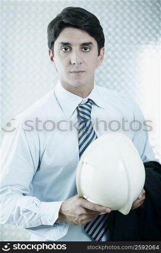 Portrait of a businessman holding a hardhat