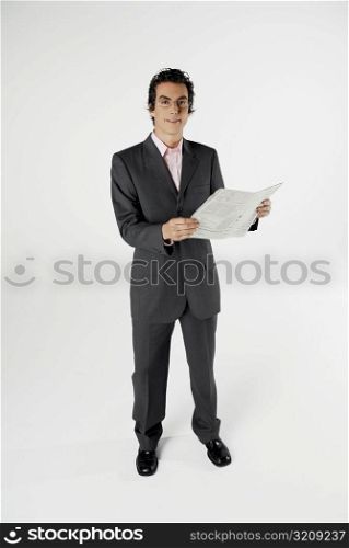 Portrait of a businessman holding a newspaper