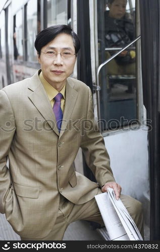 Portrait of a businessman holding a newspaper