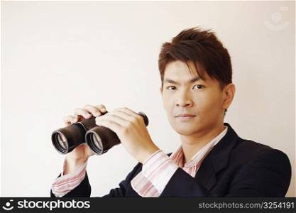 Portrait of a businessman holding a pair of binoculars