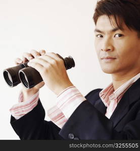 Portrait of a businessman holding a pair of binoculars