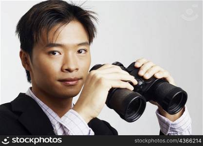 Portrait of a businessman holding a pair of binoculars