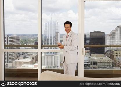 Portrait of a businessman holding a personal data assistant