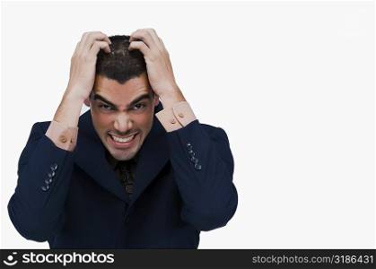Portrait of a businessman holding his head