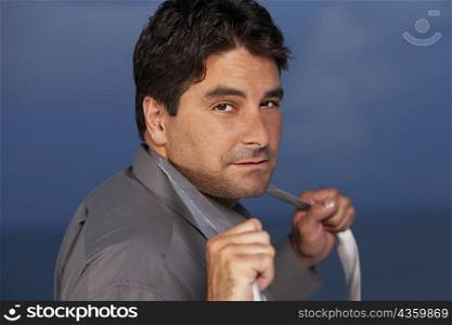 Portrait of a businessman holding his tie