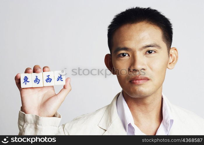 Portrait of a businessman holding marble cubes