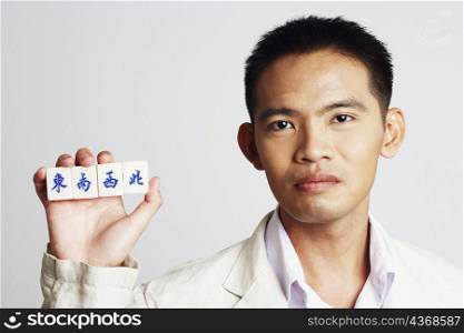 Portrait of a businessman holding marble cubes