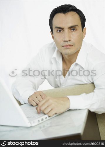 Portrait of a businessman in front of a laptop