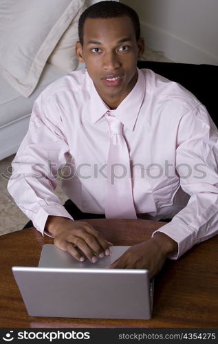 Portrait of a businessman in front of a laptop