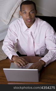 Portrait of a businessman in front of a laptop