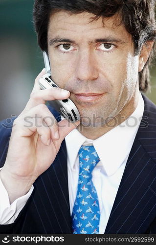 Portrait of a businessman listening a mobile phone