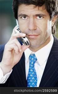 Portrait of a businessman listening a mobile phone