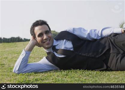Portrait of a businessman lying down , INDIA , DELHI