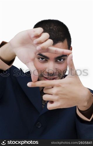 Portrait of a businessman making a finger frame