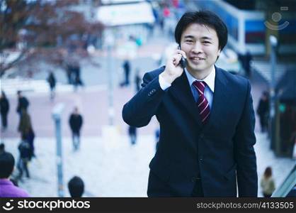 Portrait of a businessman man talking on a mobile phone