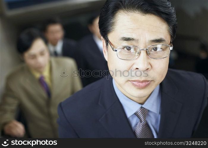 Portrait of a businessman on an escalator