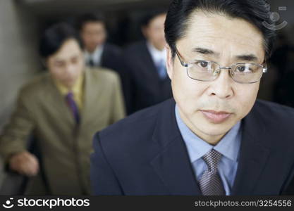 Portrait of a businessman on an escalator