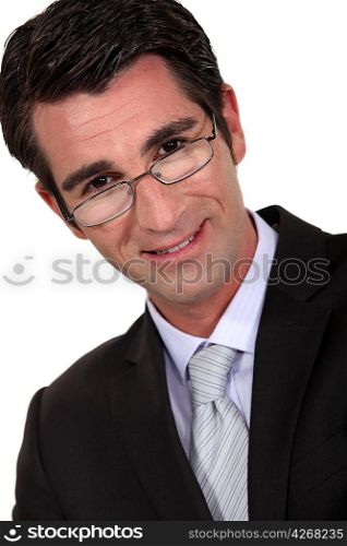 Portrait of a businessman peering over his glasses