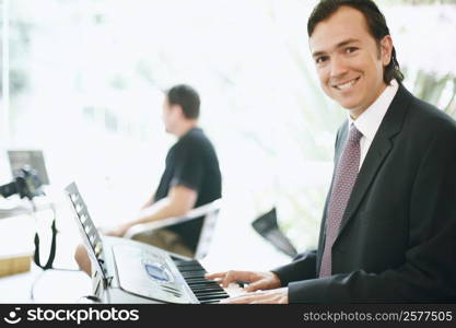 Portrait of a businessman playing the piano