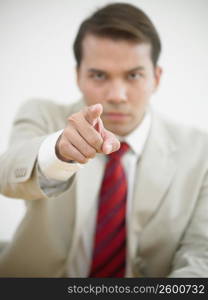 Portrait of a businessman pointing forward