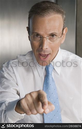 Portrait of a businessman pointing forward