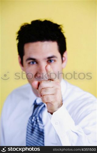 Portrait of a businessman pointing forward with his finger