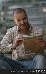 Portrait of a businessman received envelope reading documents