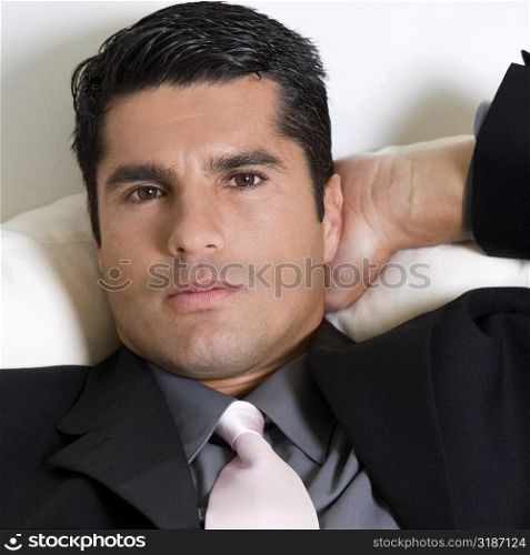Portrait of a businessman relaxing with his hand behind his head