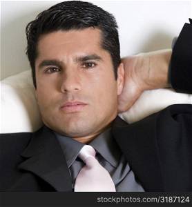Portrait of a businessman relaxing with his hand behind his head