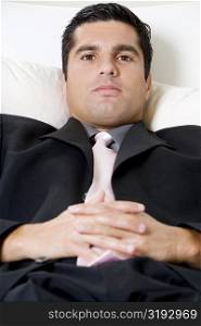 Portrait of a businessman resting on a couch