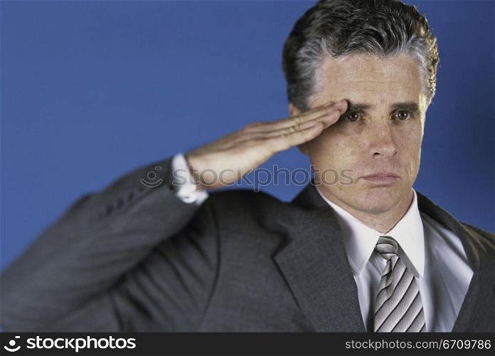 Portrait of a businessman saluting