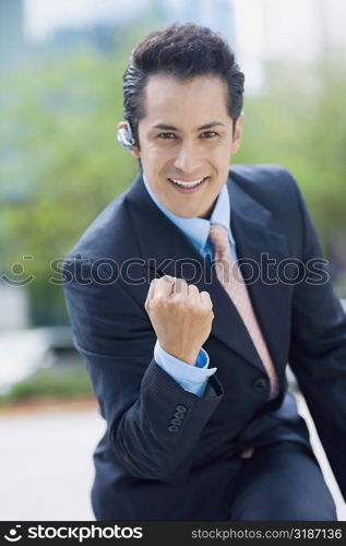Portrait of a businessman showing his fist and smiling