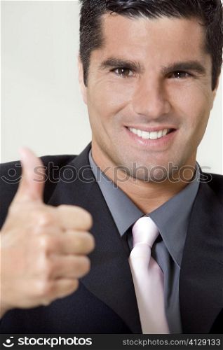 Portrait of a businessman showing thumbs up