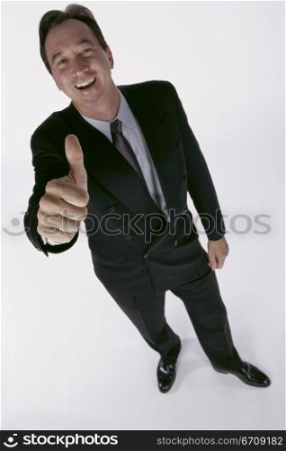 Portrait of a businessman showing thumbs up sign