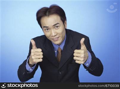 Portrait of a businessman showing thumbs up sign