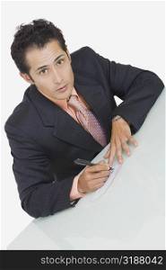 Portrait of a businessman signing a check