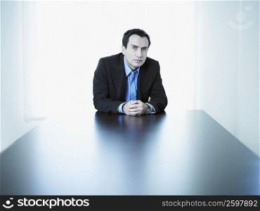 Portrait of a businessman sitting at a conference table