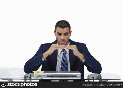Portrait of a businessman sitting at a desk and gesturing