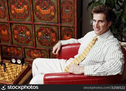 Portrait of a businessman sitting in an armchair and smiling