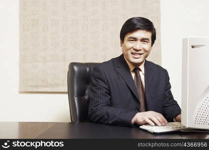 Portrait of a businessman sitting in an office smiling