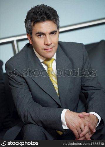 Portrait of a businessman sitting on a couch and smiling